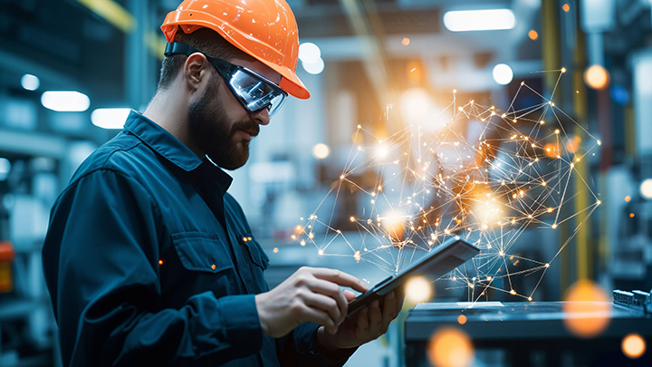 A focused industrial worker engages with advanced technology whi